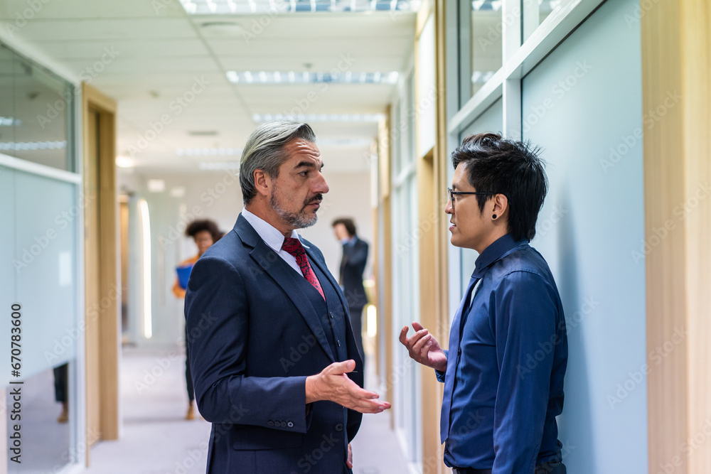 Caucasian businessman working with Asian team in the office workplace.  