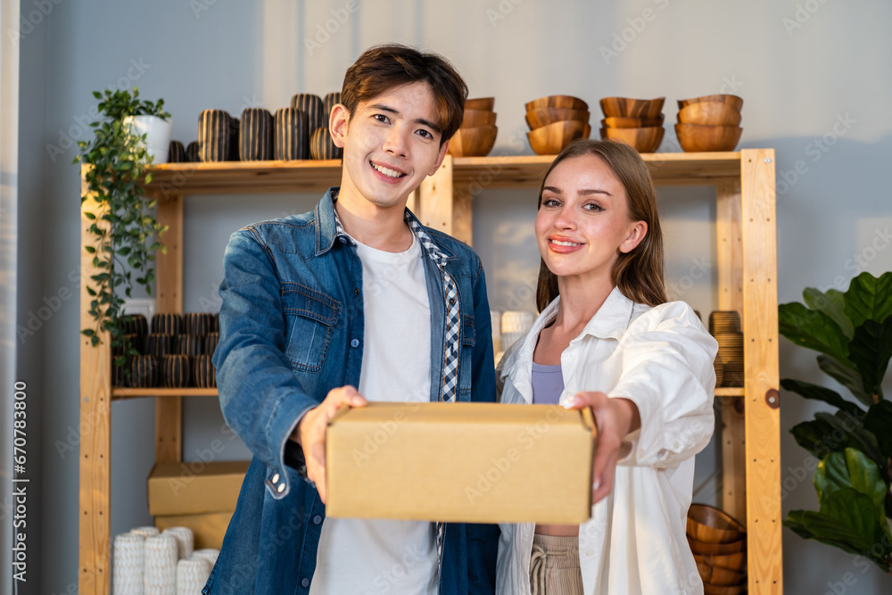 Portrait young man and woman check vase order on shelf for customer. 