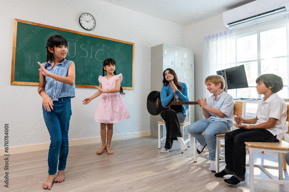 Group of student learn with teacher in classroom at elementary school. 