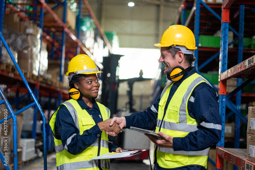 Diverse industrial worker team working in manufacturing plant together. 