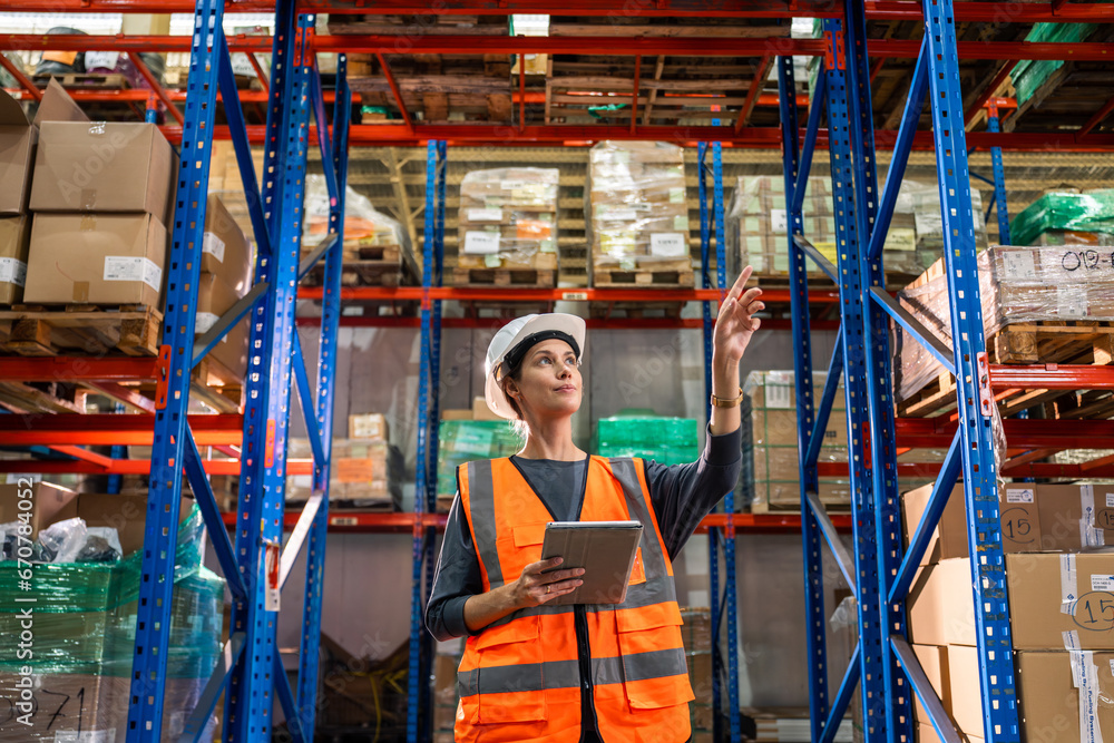 Caucasian young woman industrial worker working in manufacturing plant. 