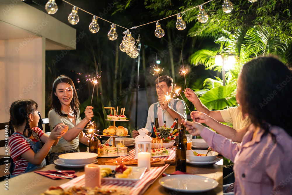 Multi-ethnic big family having fun, enjoy party outdoors in the garden. 