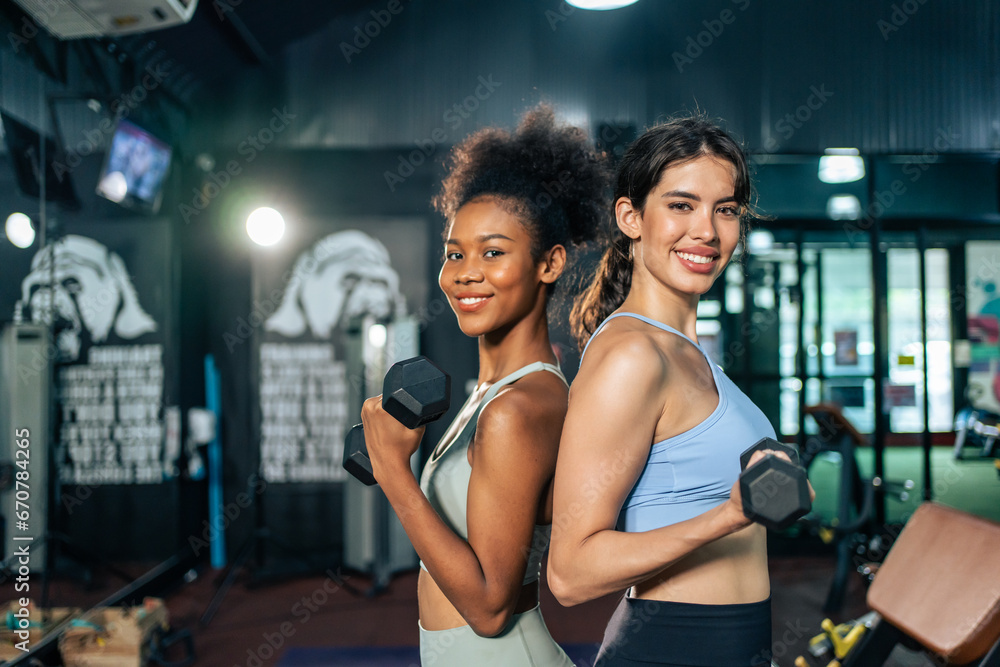 Portrait of African american and Latino sportswoman exercise in gym.