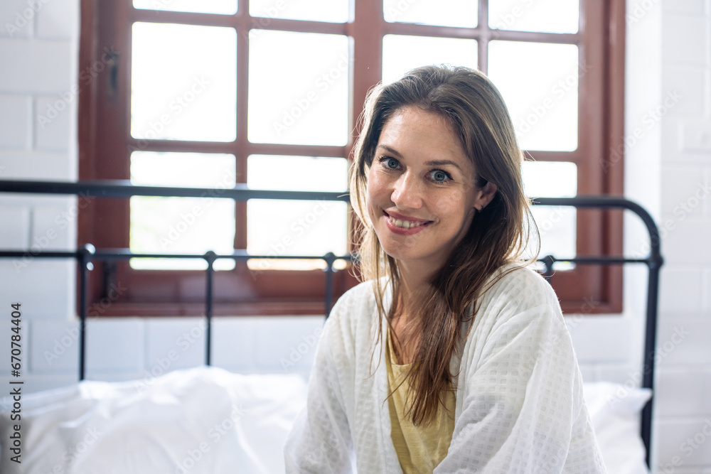 Portrait of Caucasian young girl in pajamas smile and look at camera. 