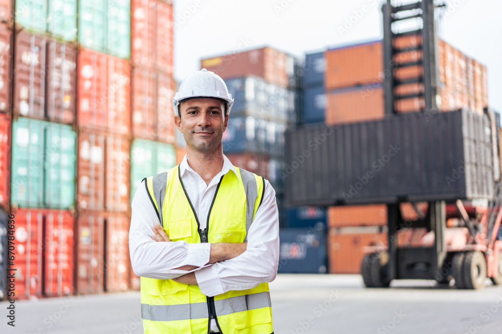 Portrait of Caucasian man worker working in container port terminal. 