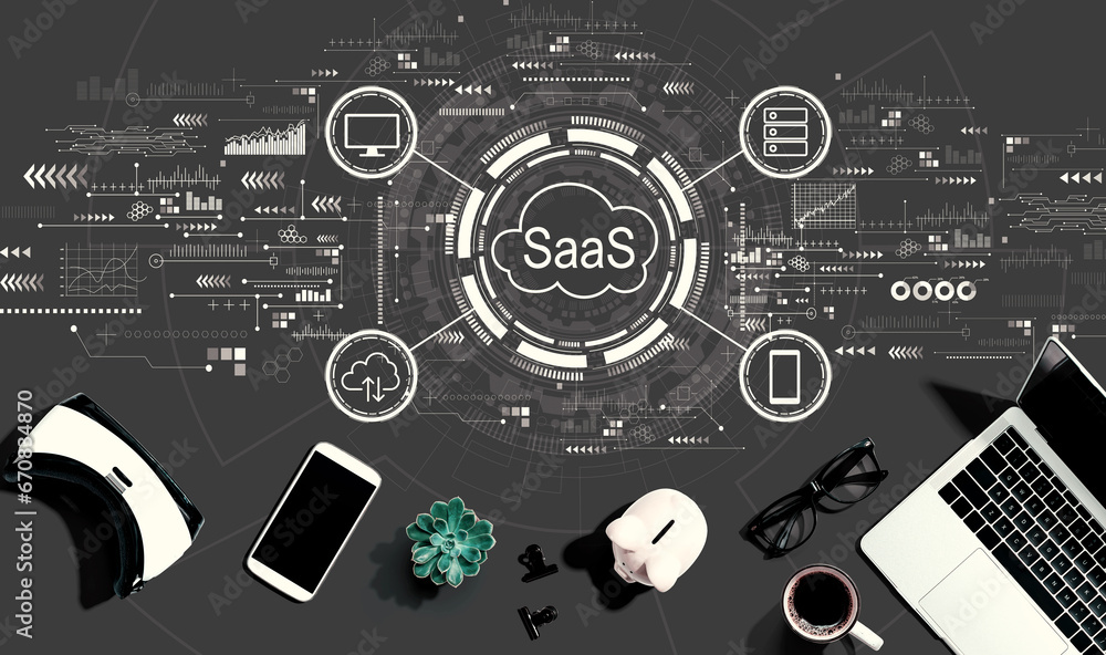 SaaS - software as a service concept with electronic gadgets and office supplies - flat lay