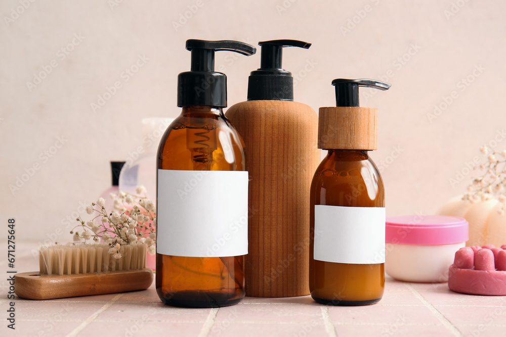 Bottles of shampoo and brush on table