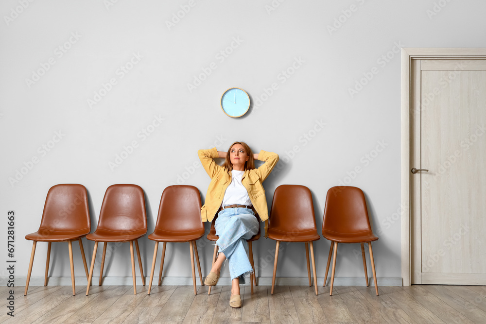 Mature woman waiting for her turn in room