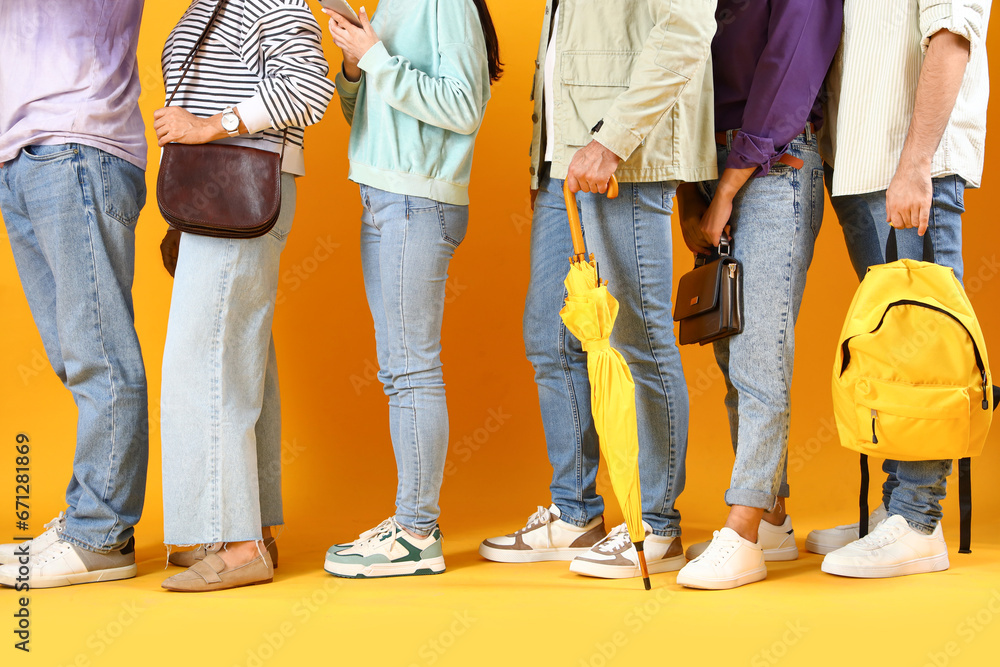 People waiting in line on yellow background