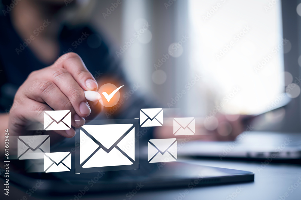 Businessmen use laptops with communication icons, letter icons, email icons, and newsletter email and protect your personal information or spam mail, Customer service call center contact.