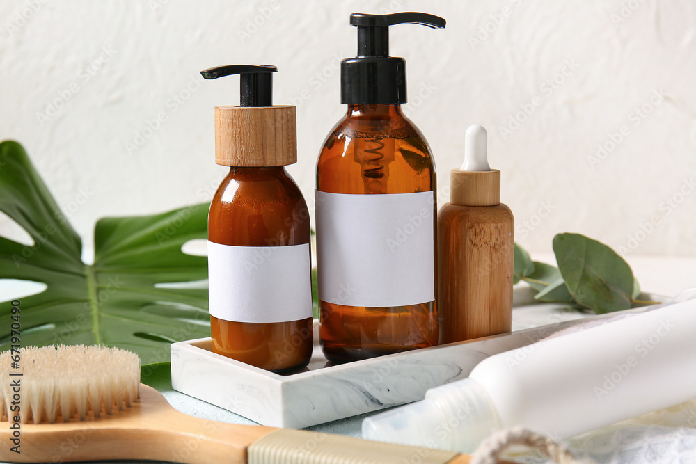 Different bottles of shampoo on white background