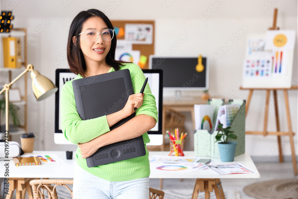 Asian interior designer with graphic tablet in office