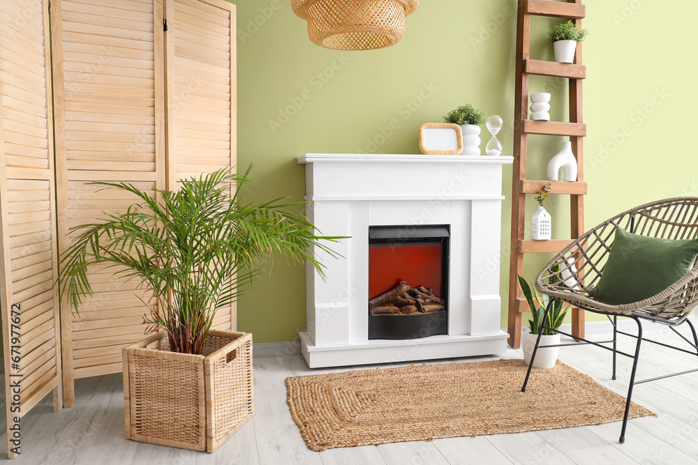 Interior of room with modern fireplace and houseplants