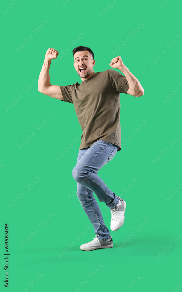 Happy young man on green background