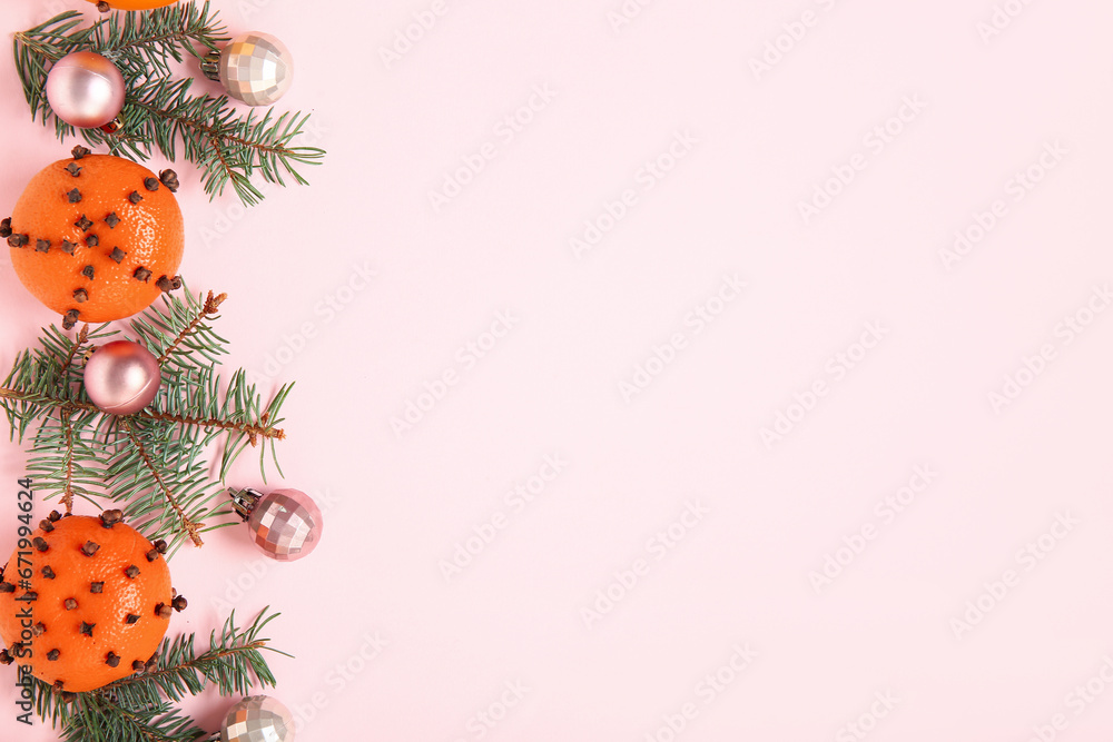 Pomander balls with Christmas tree branches and balls on pink background