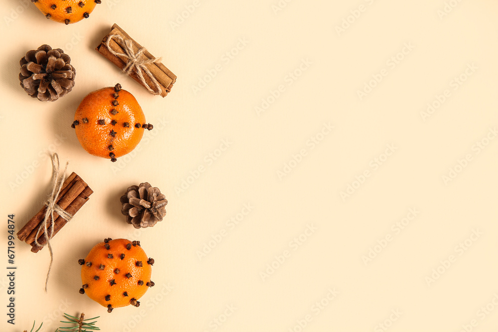 Pomander balls with cinnamon and cones on yellow background