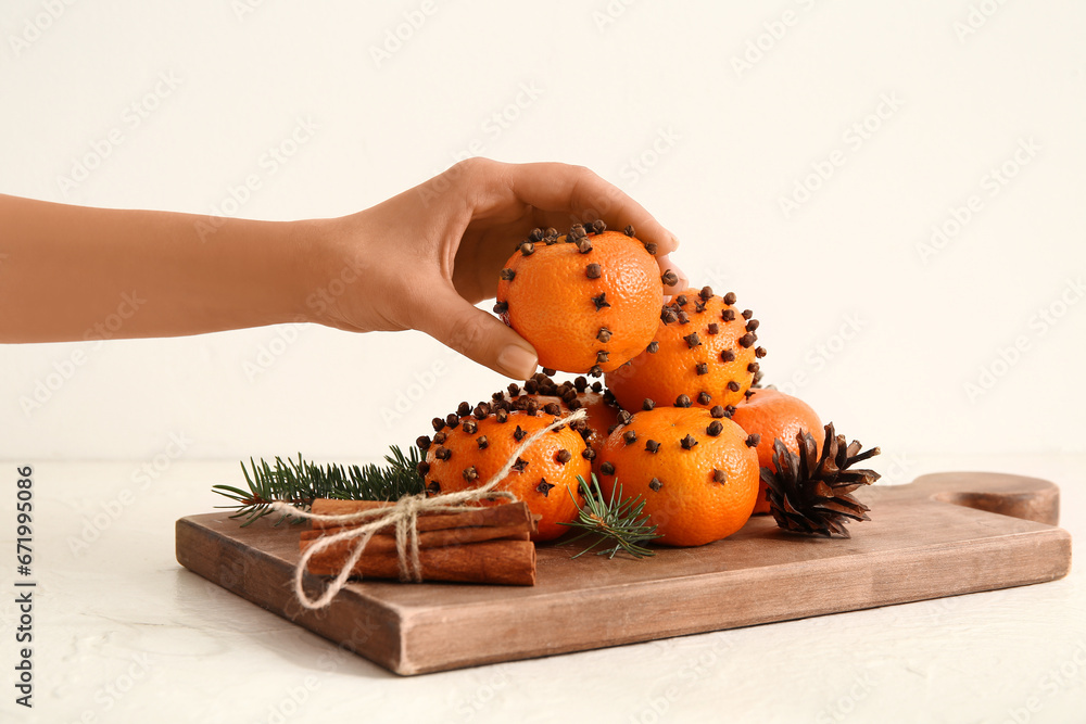 Female hand with pomander ball on white background