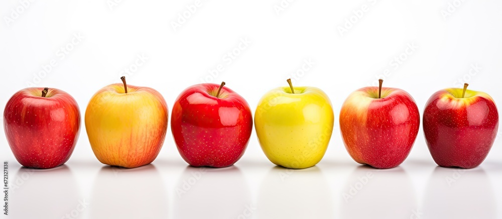 A group of apples still with their peel intact positioned separately on a white background