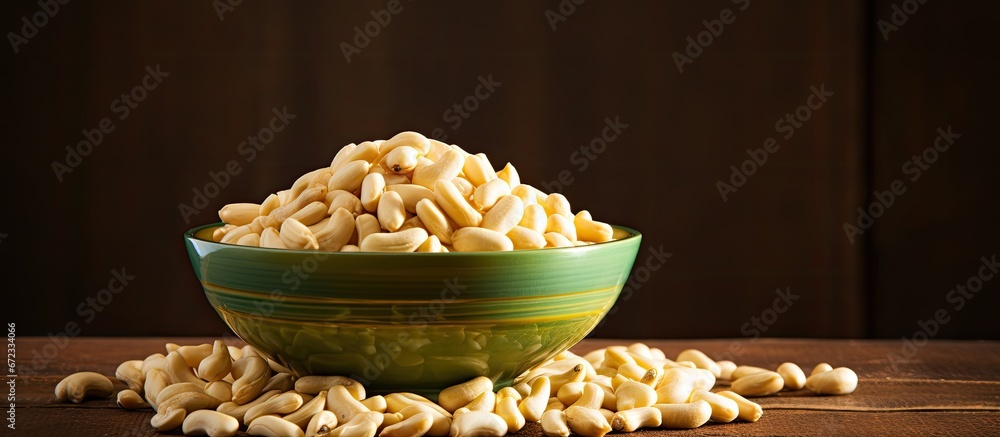 A bowl filled with a collection of shelled peanuts or beans placed against a backdrop suitable for agriculture and food