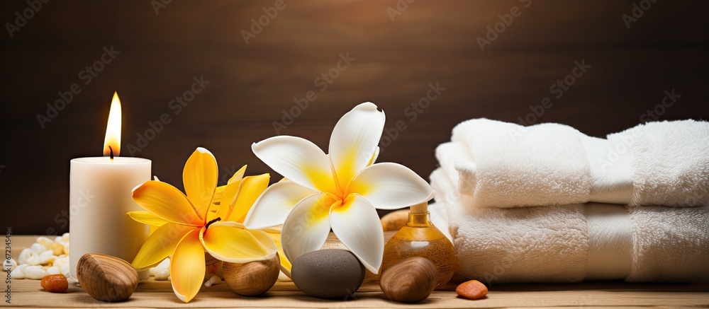 A serene scene in the spa featuring fragrant candles Frangipani blossoms and a towel