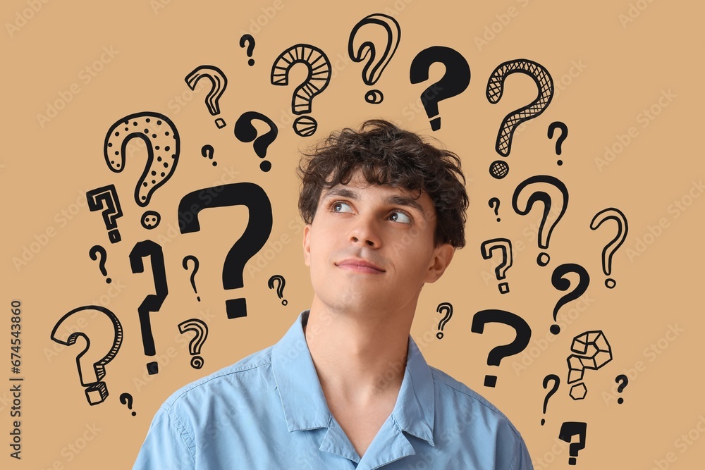 Thoughtful young man and many question marks on beige background