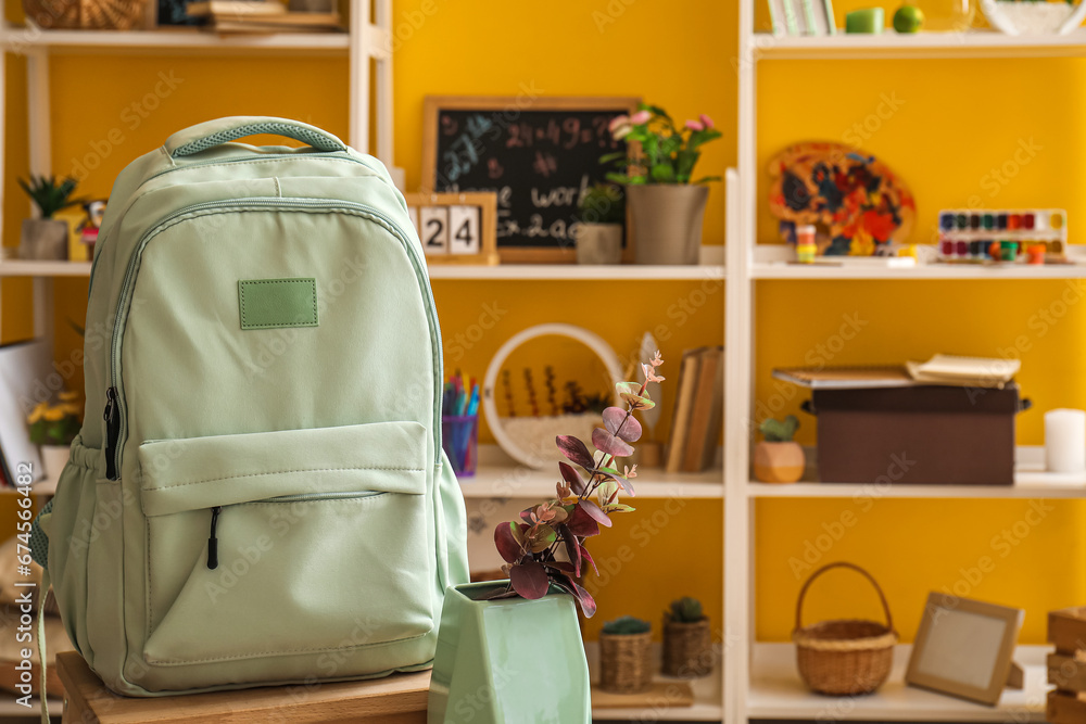 School backpack on chair in room