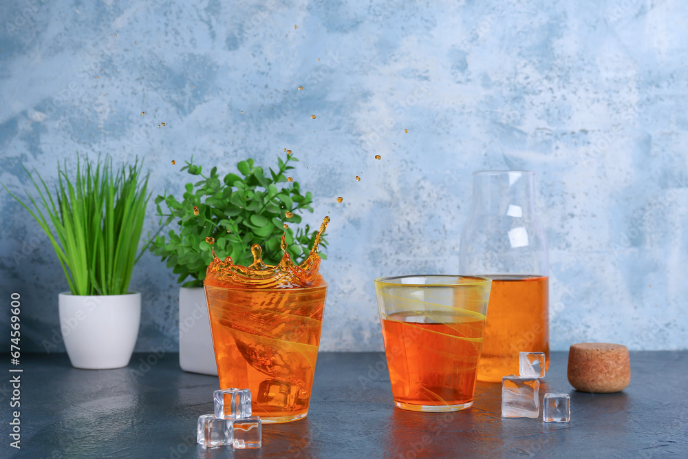 Glasses of fresh lemonade with ice cubes and mint on table