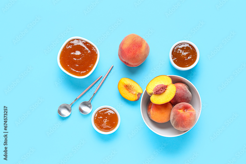 Composition with bowls of sweet peach jam and fresh fruits on color background