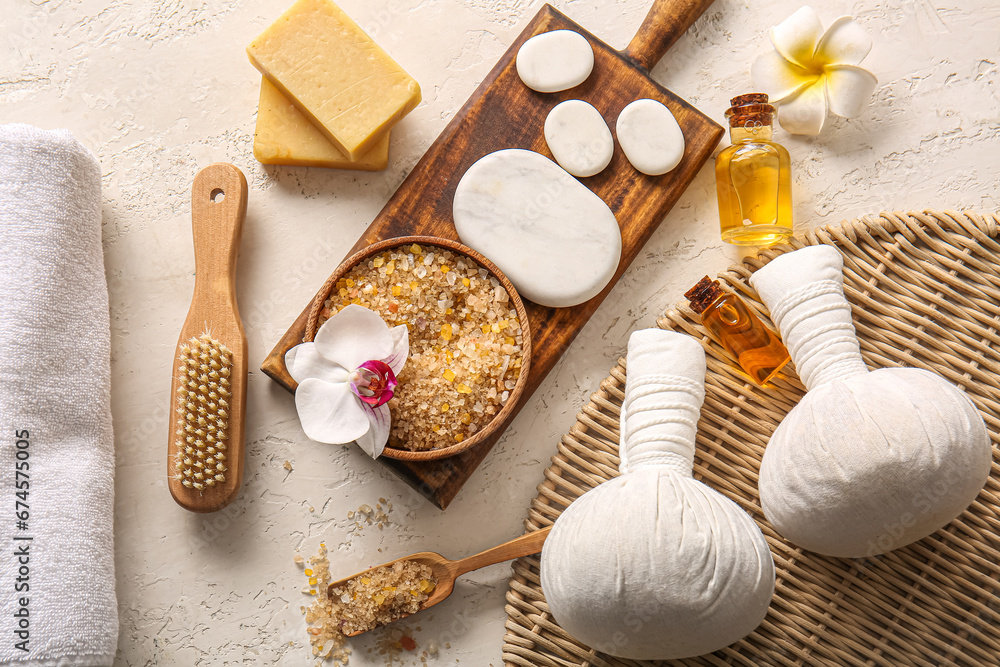 Composition with spa accessories, cosmetics and flowers on light background