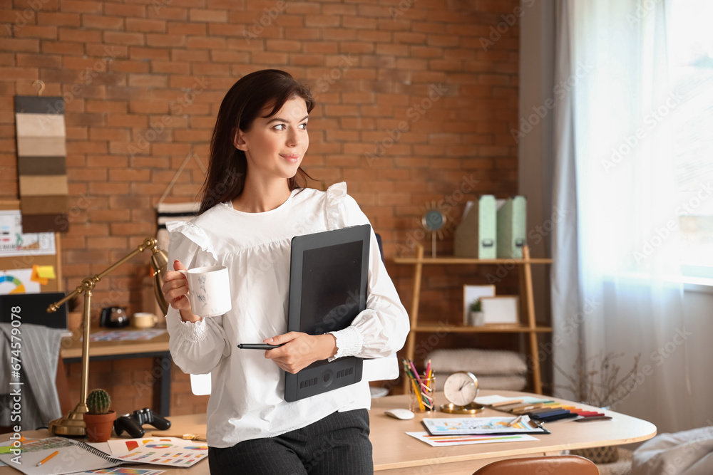 Female interior designer with graphic tablet in office