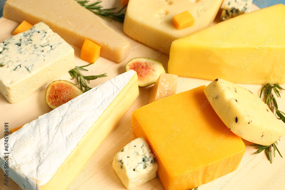 Tasty cheese on wooden board, closeup