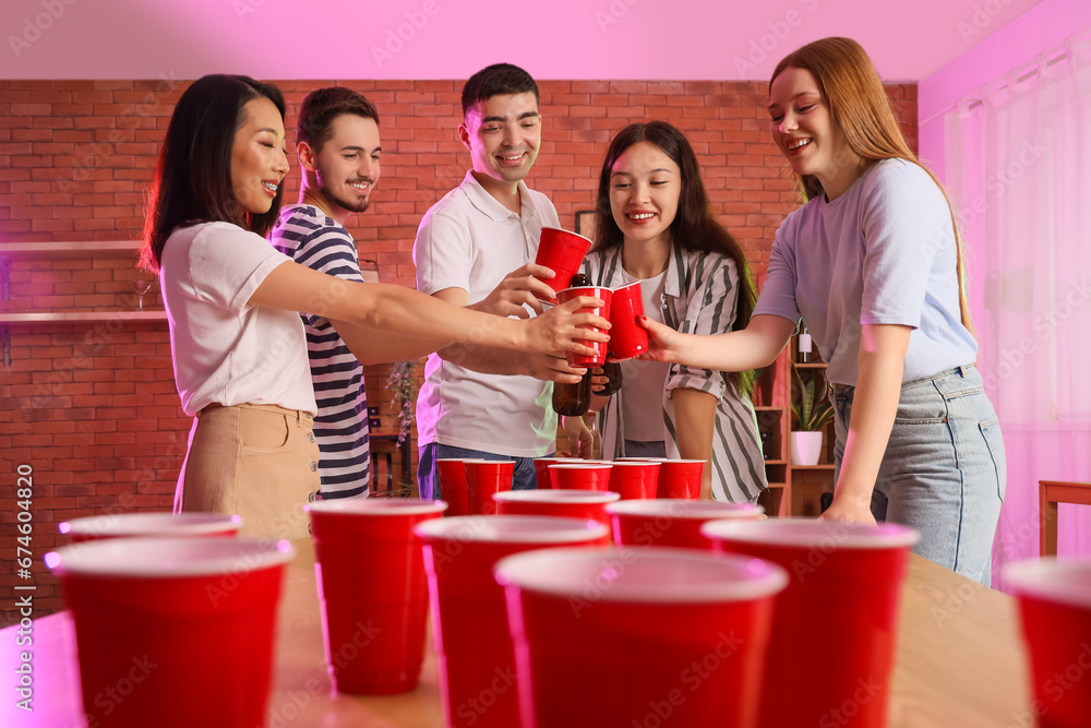 Group of young friends drinking beer at party