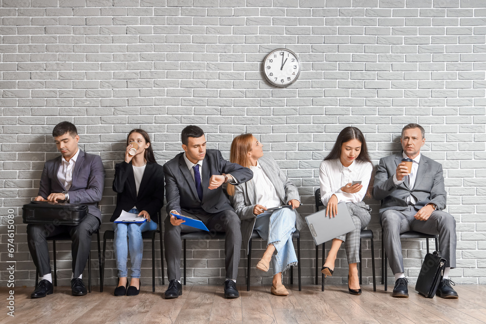 Business people waiting for their turn in office hall