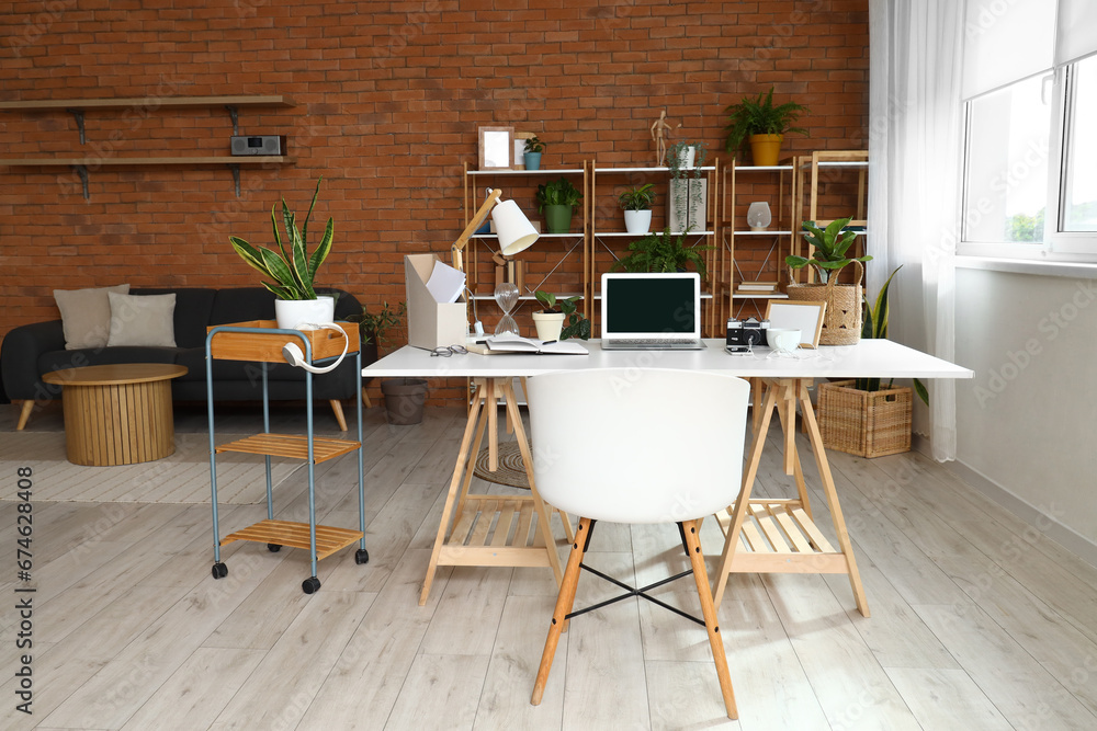 Interior of home office with workplace and shelf unit