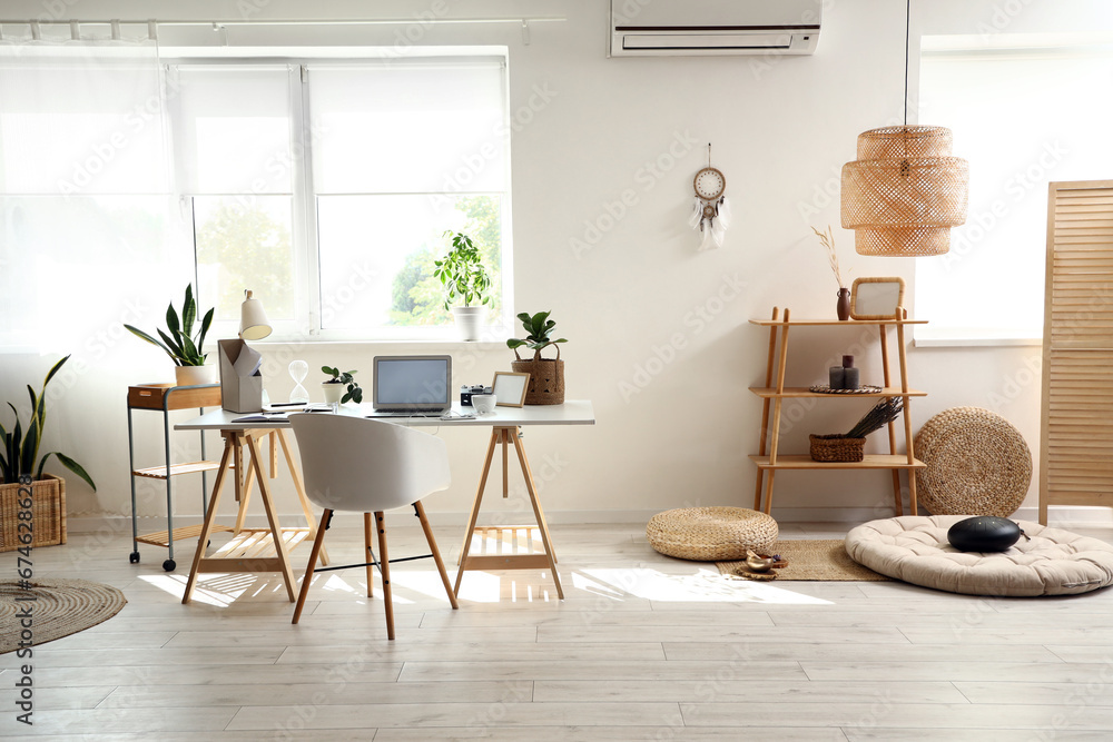 Interior of home office with workplace and shelf unit