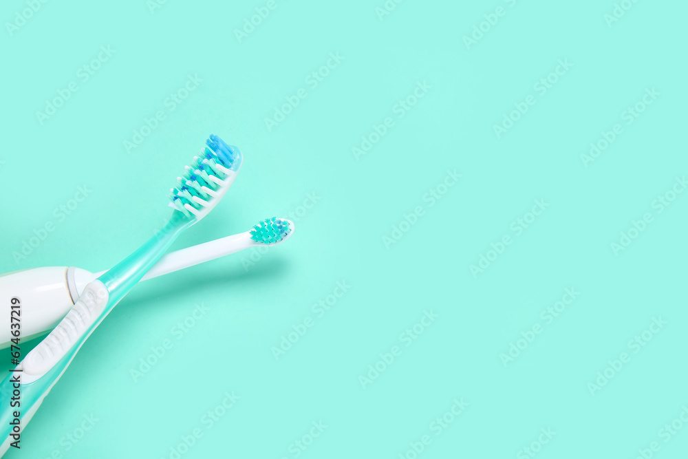 Electric and plastic toothbrushes on color background.