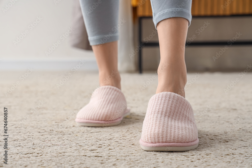 Young woman in soft slippers at home, closeup