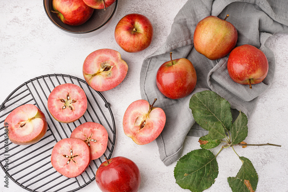 Stand with cut pink apple and leaves on white background