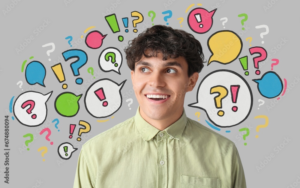 Young man and many speech bubbles with question and exclamation marks on grey background