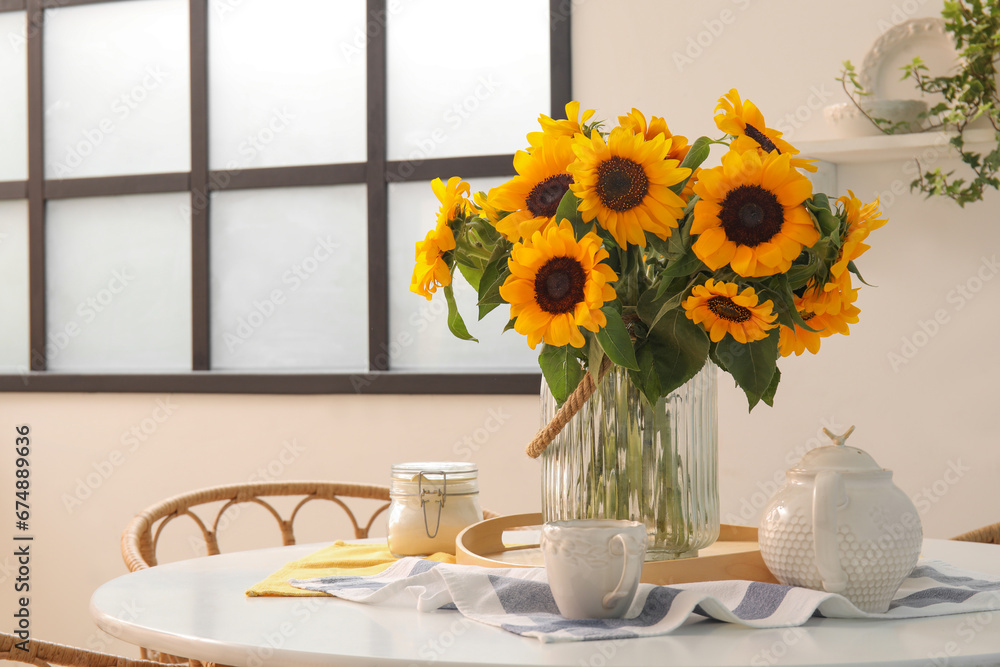 Vase with beautiful sunflowers on dining table, closeup