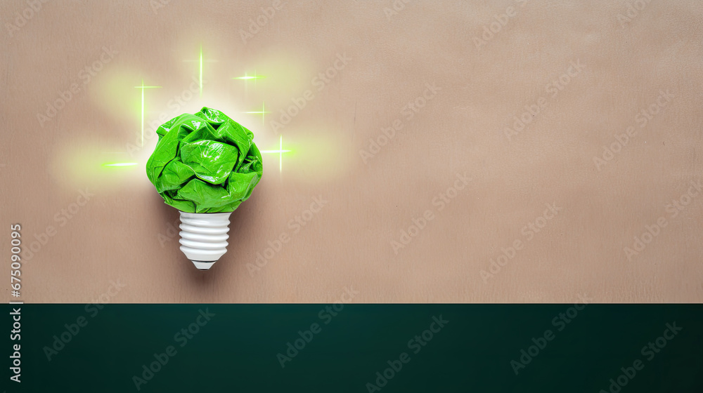 Green crumpled paper light bulb on brown background, Corporate Social Responsibility (CSR), eco-friendly business and environmental concept with copy space