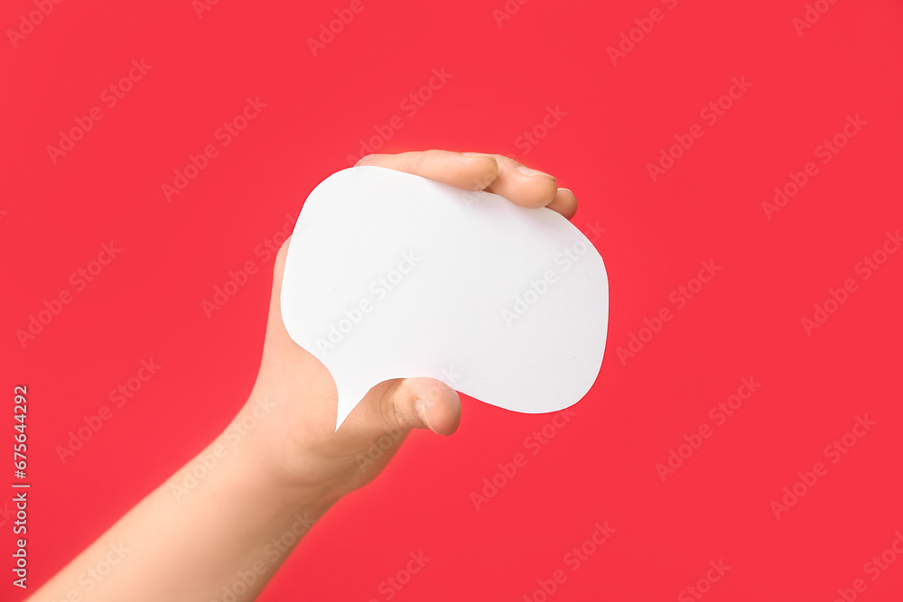 Woman holding blank speech bubble on red background