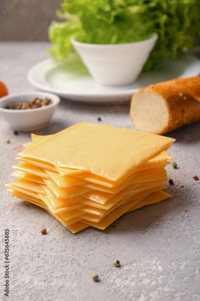 Slices of tasty processed cheese on table