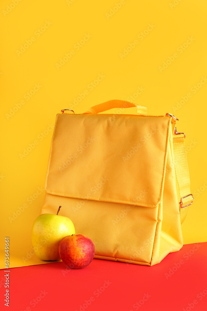 Lunch box bag and fruits on color background