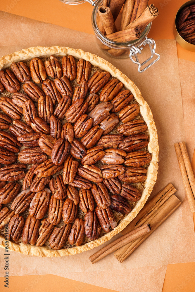 Tasty pecan pie on orange background