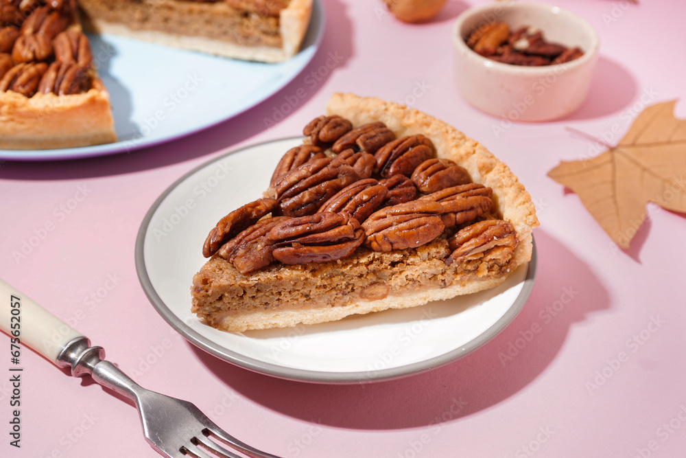 Plate with piece of tasty pecan pie on pink background