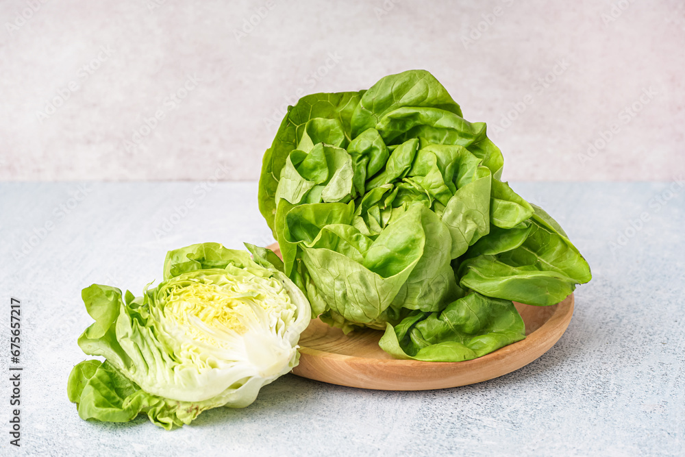 Plate with fresh Boston lettuce on white background