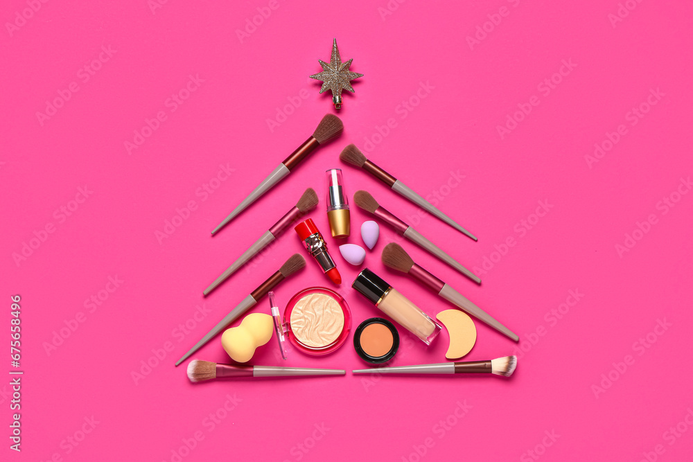 Christmas tree made of makeup products and decor on pink background