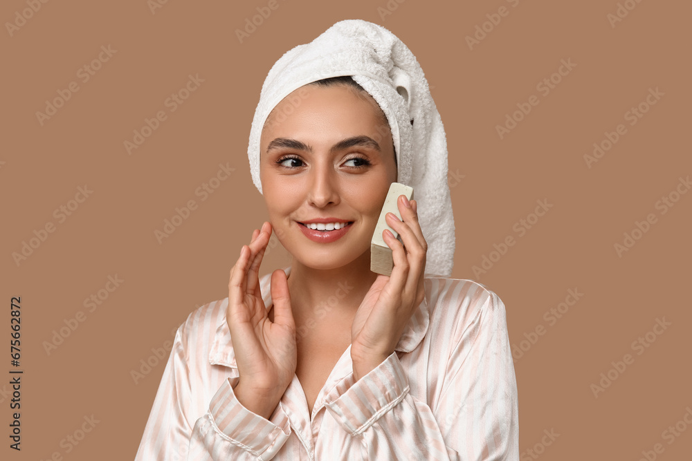 Young woman with soap on brown background, closeup