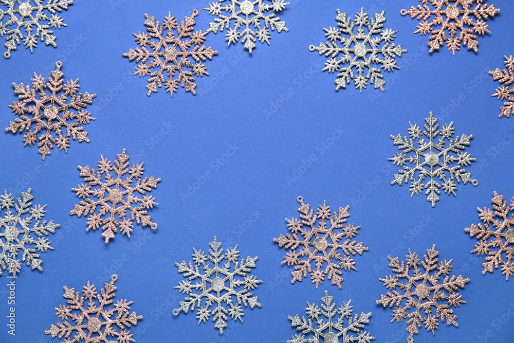 Many beautiful snowflakes on blue background